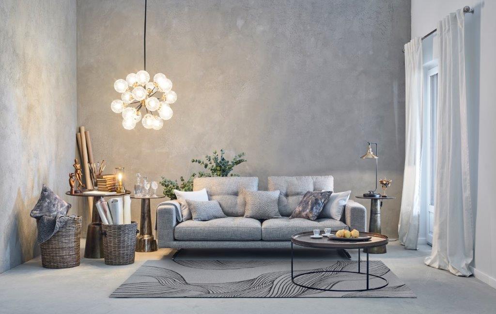 Szary nowoczesny dywan z abstrakcyjnym wzorem w eleganckim salonie z betonową ścianą i designerską lampą